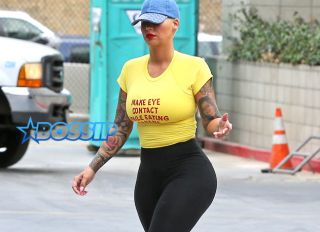 FameFlynetPictures Amber Rose hips gym yellow tee day of Kanye Beef 1/27 yellow shirt make eye contact while eating a banana