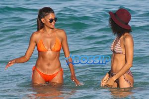 AKM-GSI Model Claudia Jordan, 42, actress Annie Ilonzeh, 32, bikini bodies in Miami Beach New Years day.