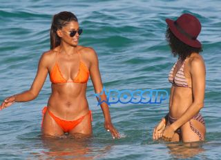 AKM-GSI Model Claudia Jordan, 42, actress Annie Ilonzeh, 32, bikini bodies in Miami Beach New Years day.