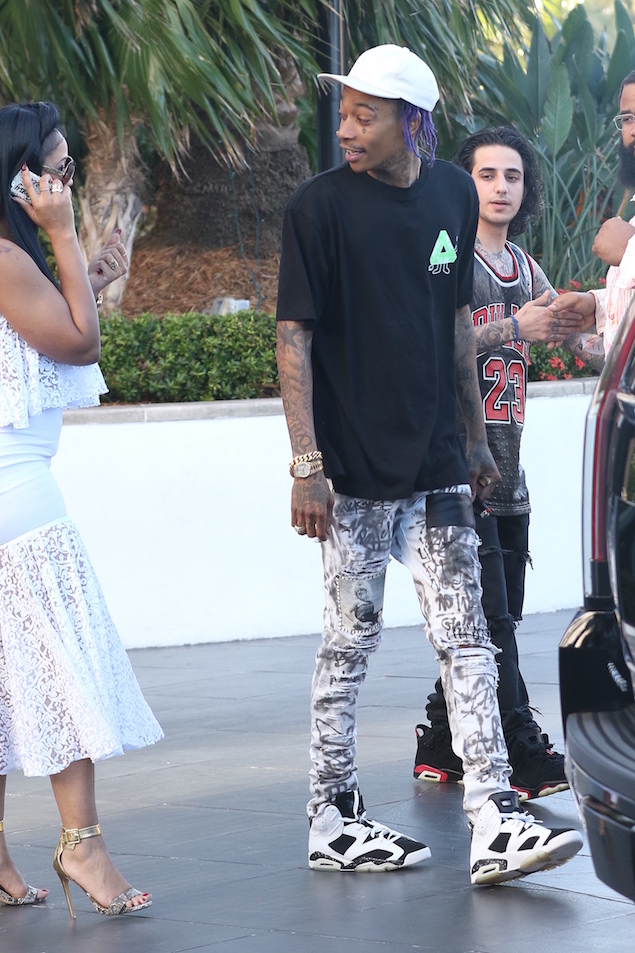 Wiz Khalifa was spotted this afternoon with a female friend in South Beach