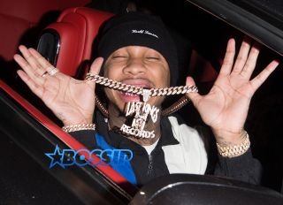 SplashNews Tyga shows off his gold chains as he leaves Hyde Night Club in West Hollywood