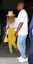 Jay Z and Beyonce leave their midtown office for his niece's graduation party. yellow pants white top white blazer straw hat and yellow handbag. AKM-GSI 27 MAY 2016