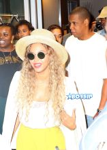 Jay Z and Beyonce leave their midtown office for his niece's graduation party. yellow pants white top white blazer straw hat and yellow handbag. AKM-GSI 27 MAY 2016