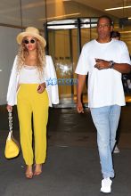 Jay Z and Beyonce leave their midtown office for his niece's graduation party. yellow pants white top white blazer straw hat and yellow handbag. AKM-GSI 27 MAY 2016