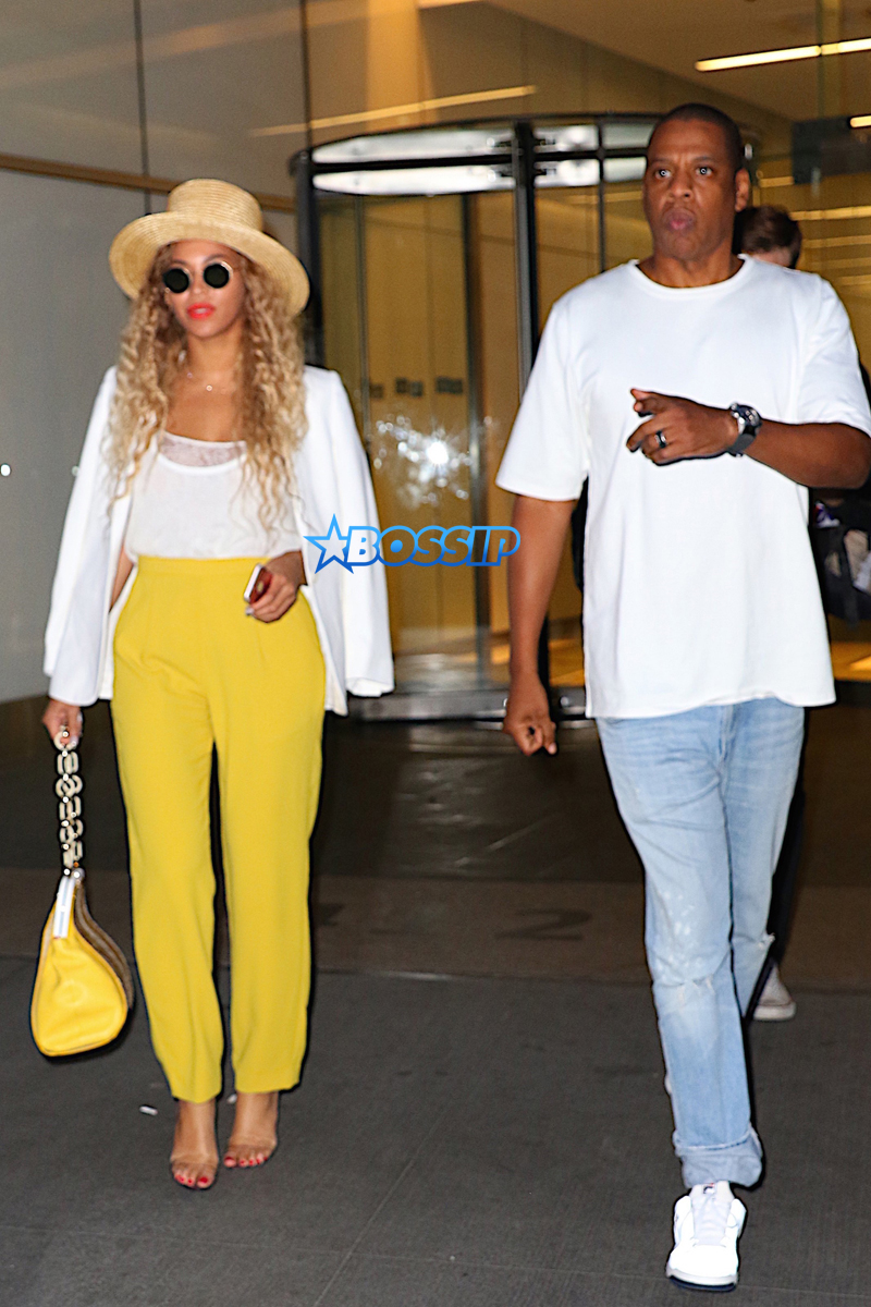 Jay Z and Beyonce leave their midtown office for his niece's graduation party.  yellow pants white top  white blazer  straw hat and yellow handbag.        AKM-GSI 27 MAY 2016 