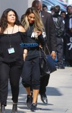 AKM-GSI Ciara hides behind staff as she arrives at the El Capitan Theatre in Hollywood for the taping of 'Jimmy Kimmel Live'.