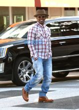 AKM-GSI Jamie Foxx playing around toy motor bike Lil Go-Go. mystery woman relationship with Katie Holmes. plaid button up paired, camel boots and a hat.