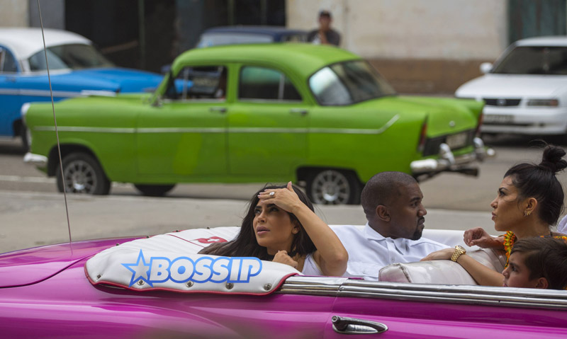 Kim Kardashian West sits in a classic convertible car with her husband Kanye West and her sister Kourtney Mary Kardashian, right, in Havana, Cuba, Wednesday, May 4, 2016. They visited Havanaís Museum of Rum Wednesday, stepping out of a hot-pink antique American convertible as they snapped selfies and were recorded by a television crew following them around.(AP Photo/Desmond Boylan)