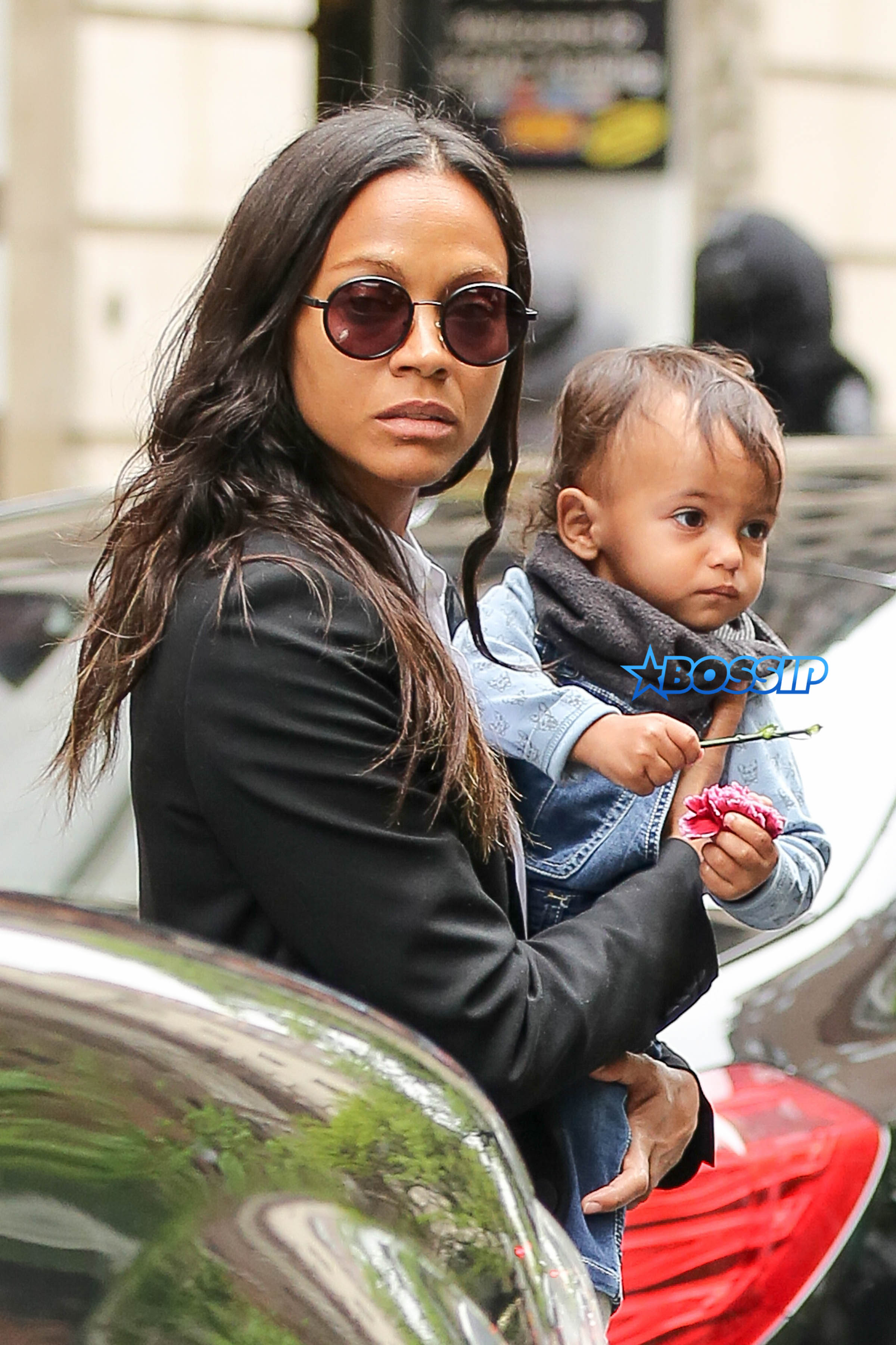 Zoe Saldana and Marco Perego seen carrying their kids while their where checking out their hotel in New York City