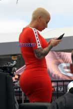 AKM-GSI Amber Rose wore body hugging red dress with white details for Extra interview with Mario Lopez