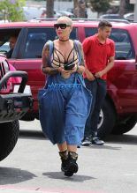 AKM-GSI Amber Rose wore a scrappy lingerie top under baggy overalls with combat boots to lunch at Cheesecake Factory with her assistant