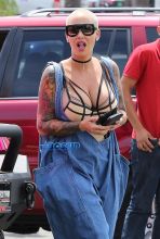 AKM-GSI Amber Rose wore a scrappy lingerie top under baggy overalls with combat boots to lunch at Cheesecake Factory with her assistant