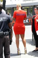 AKM-GSI Amber Rose wore body hugging red dress with white details metallic heels for Extra interview with Mario Lopez