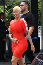 AKM-GSI Amber Rose wore body hugging red dress with white details metallic heels for Extra interview with Mario Lopez