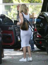 'KUWTK', Khloe Kardashian, curves white jersey dress and white sneakers. She was seen eating with mom, Kris Jenner, and sister, Khloe Kardashian, at The Villa Restaurant. AKM-GSI