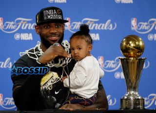 Cleveland Cavaliers' LeBron James answers questions as he holds his daughter Zhuri during a post-game press conference after Game 7 of basketball's NBA Finals Sunday, June 19, 2016, in Oakland, Calif. Cleveland won 93-89. (AP Photo/Eric Rosberg) Zhuri Nova Bryce Maximus Lebron Jr