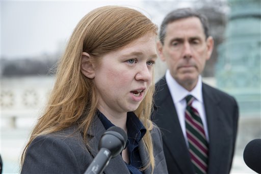 Abigail Fisher, who challenged the use of race in college admissions, joined by lawyer Edward Blum, right, speaks to reporters outside the Supreme Court in Washington, Wednesday, Dec. 9, 2015, following oral arguments in the Supreme Court in a case that could cut back on or even eliminate affirmative action in higher education. (AP Photo/J. Scott Applewhite)