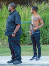 Rapper Slim Jimmy steps out of his limo to pee on the side of the road in Los Angeles, California on June 7, 2016. Slim, who had no shirt on, peed behind a tree. FameFlynet, Inc -