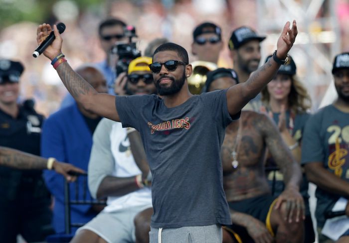 Cleveland Cavaliers' Kyrie Irving acknowledges the crowd during a rally, Wednesday, June 22, 2016, in Cleveland. The Cavaliers made history by overcoming a 3-1 deficit to beat the Golden State Warriors in the NBA Finals and end the city's 52-year drought without a professional sports championship.(AP Photo/Tony Dejak)