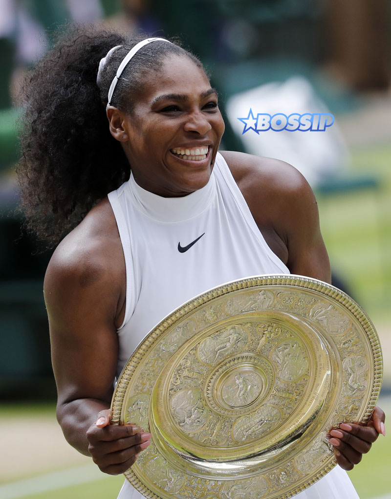 Serena Williams of the U.S holds up the trophy after beating Angelique Kerber of Germany in the women's singles final on day thirteen of the Wimbledon Tennis Championships in London, Saturday, July 9, 2016. (AP Photo/Ben Curtis)