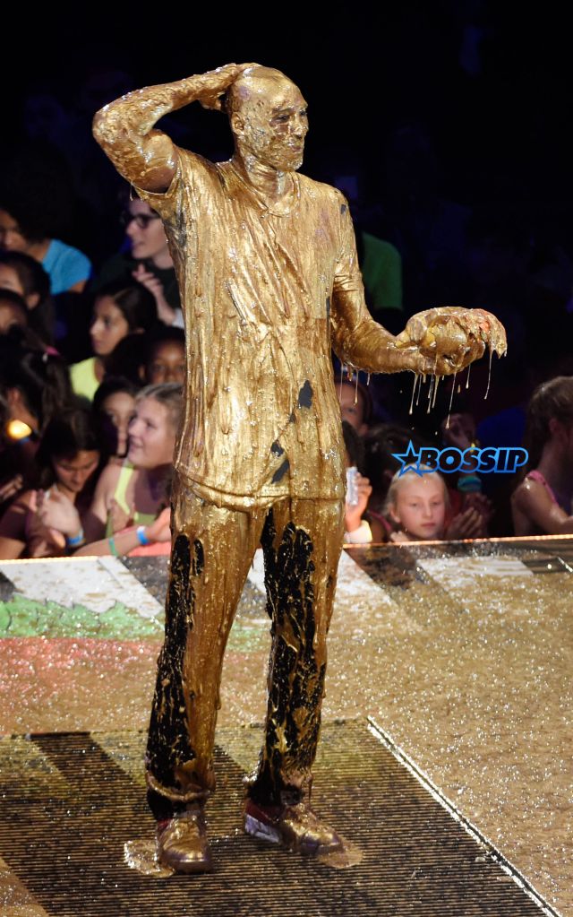 Retired NBA basketball player and Legend Award recipient Kobe Bryant stands onstage after being "slimed" during the 2016 Kids' Choice Sports Awards at Pauley Pavilion on Thursday, July 14, 2016, in Los Angeles. (Photo by Chris Pizzello/Invision/AP)