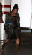 SplashNews Kim Kardashian nude bikini top black bottoms with black sheer netted jumpsuit camouflage jacket boots hair in a bun Kim Kardashian Skyspace launch
