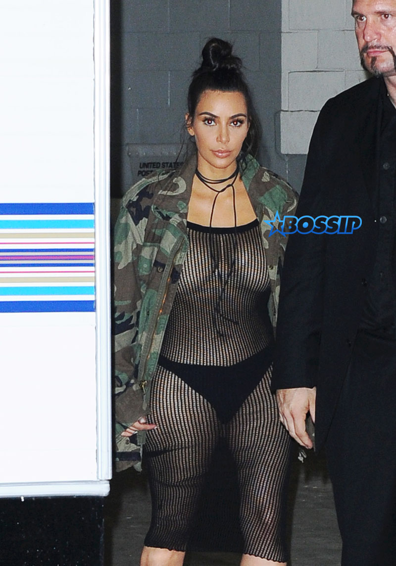 SplashNews Kim Kardashian nude bikini top black bottoms with black sheer netted jumpsuit camouflage jacket boots hair in a bun Kim Kardashian Skyspace launch