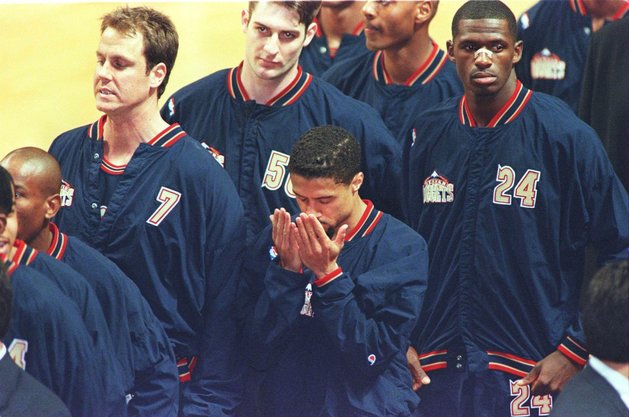 15 Mar 1996:  Point guard Mahmoud Abdul-Rauf of the Denver Nuggets stands in prayer during the singing of the National Anthem before the Nuggets game against the Chicago Bulls at the United Center in Chicago, Illinois.  Abdul-Rauf came to an agreement with the NBA after a suspension for sitting during previous game's anthem. Mandatory Credit: BRIAN BAHR/ALLSPORT