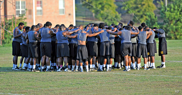 The Grambling football team says a prayer after holding a warmup session on the practice field before moving indoors for conditioning drills  Monday, Oct. 21, 2013.  (AP Photo/The Shreveport Times, Douglas Collier)