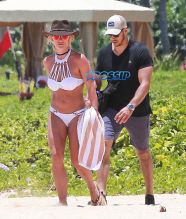 Kauai, HI Britney Spears vacation Hawaii scrappy white bikini, hot pink shorts cowboy hat toned body beach kids played sand FameFlynet/AKM-GSI