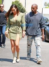 Kanye West Kim Kardashian at Ysabel restaurant in West Hollywood on July 31, 2016. short army green lace up dress Louis Vuitton purse The Petite Metallic. FameFlynet