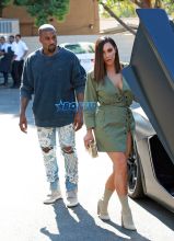 Kanye West Kim Kardashian at Ysabel restaurant in West Hollywood on July 31, 2016. short army green lace up dress Louis Vuitton purse The Petite Metallic. FameFlynet
