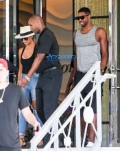 FameFlynetPictures Khloe Kardashian Tristan Thompson Miami Lunch Kim Kardashian holding hands fitted pants tank tops sunglasses North West