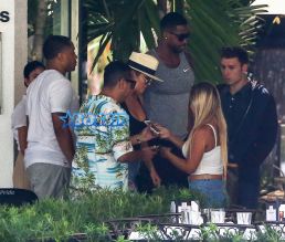 FameFlynetPictures Khloe Kardashian Tristan Thompson Miami Lunch Kim Kardashian holding hands fitted pants tank tops sunglasses North West