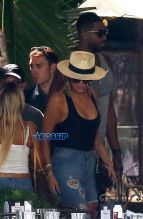 FameFlynetPictures Khloe Kardashian Tristan Thompson Miami Lunch Kim Kardashian holding hands fitted pants tank tops sunglasses North West