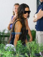 FameFlynetPictures Khloe Kardashian Tristan Thompson Miami Lunch Kim Kardashian holding hands fitted pants tank tops sunglasses North West