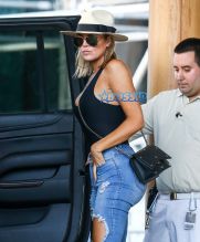 FameFlynetPictures Khloe Kardashian Tristan Thompson Miami Lunch Kim Kardashian holding hands fitted pants tank tops sunglasses North West