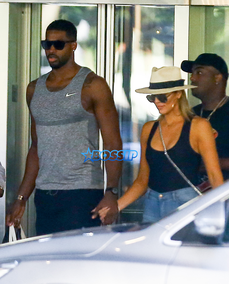 FameFlynetPictures Khloe Kardashian Tristan Thompson Miami Lunch Kim Kardashian holding hands fitted pants tank tops sunglasses North West