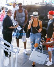 FameFlynetPictures Khloe Kardashian Tristan Thompson Miami Lunch Kim Kardashian holding hands fitted pants tank tops sunglasses North West