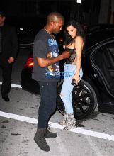 Kim Kardashian Kanye West Prime One Twelve dinner in Miami SplashNews black lacy corset top wardrobe malfunction tupac gang related tee shirt