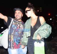 Kim Kardashian La Mer Spa NYC a green oversized bomber jacket busty black tank top cut off jeans no makeup after getting a facial SplashNews