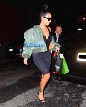 Kim Kardashian La Mer Spa NYC a green oversized bomber jacket busty black tank top cut off jeans no makeup after getting a facial SplashNews
