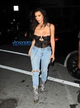 Kim Kardashian Kanye West Prime One Twelve dinner in Miami SplashNews black lacy corset top wardrobe malfunction tupac gang related tee shirt