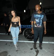 Kim Kardashian Kanye West Prime One Twelve dinner in Miami SplashNews black lacy corset top wardrobe malfunction tupac gang related tee shirt