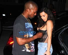 Kim Kardashian Kanye West Prime One Twelve dinner in Miami SplashNews black lacy corset top wardrobe malfunction tupac gang related tee shirt