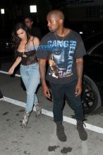 Kim Kardashian Kanye West Prime One Twelve dinner in Miami SplashNews black lacy corset top wardrobe malfunction tupac gang related tee shirt