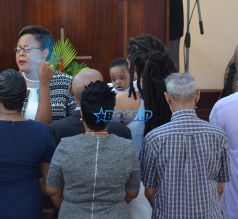 Rihanna Barbados. christening of cousin Nikolai. 11am to the Power In the Blood Assembly bestie Melissa baby blue dress and long dreadlocks. Majesty in her lap. baby's mother Nicolette, grandmother Marcel, cousin Noella altar Nikolai's dedication. SplashNews