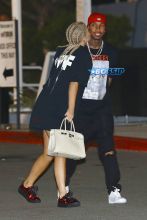 AKM-GSI Kylie Jenner boyfriend Tyga kiss Kanye West's Saint Pablo LA Tour tThe Forum. T Jordyn Woods security. dressed oversized black shirt, cherry red shoes cornrows, braids.
