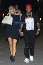 AKM-GSI Kylie Jenner boyfriend Tyga kiss Kanye West's Saint Pablo LA Tour tThe Forum. T Jordyn Woods security. dressed oversized black shirt, cherry red shoes cornrows, braids.