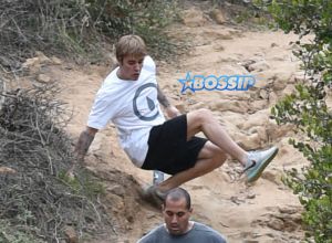 Justin Bieber run rainy windy day falls hike generosity water WENN